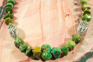 Stunning Necklace featuring Genuine Nevada Turquoise with Sterling Silver Accents Beads. Two Beautiful Sterling Silver Hand Stamped Medallions. Melon Shell Heishi, Sterling Silver Beads and Clasp.Created by Santo Domingo Artist Carol Pacheco. The Santo Domingo Pueblo is in New Mexico, near Santa Fe.